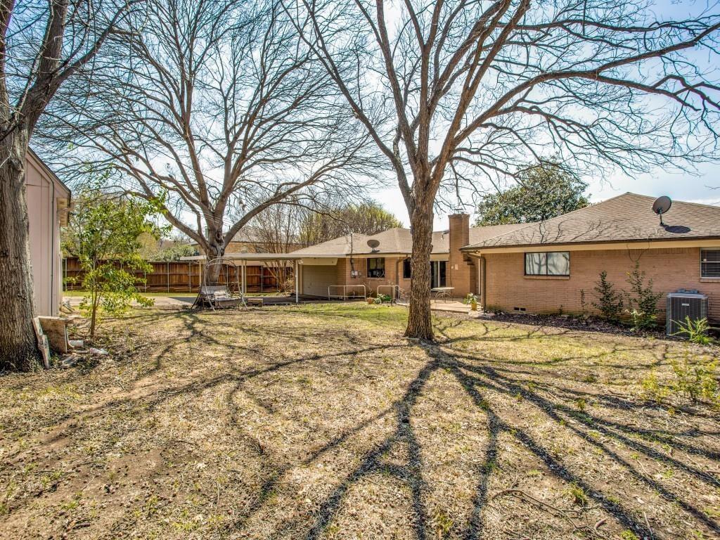 7027 Alpha Road, Unit 1 Dallas, TX 75240 - Photo 8 of 8 a front view of a house with a yard