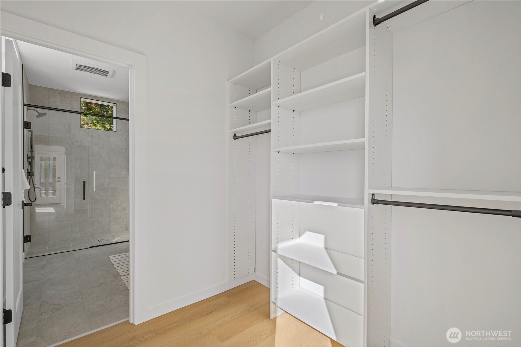 3421 Albion Place North Seattle, WA 98103 - Photo 19 of 38 a view of walk in closet with empty racks
