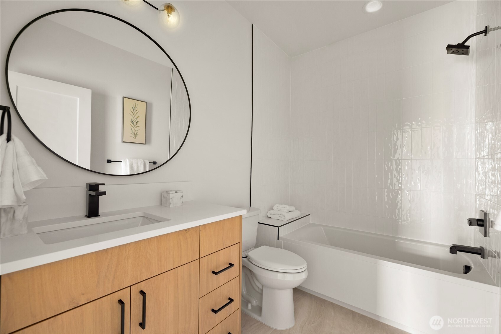 3421 Albion Place North Seattle, WA 98103 - Photo 21 of 38 a bathroom with a sink a toilet and a mirror