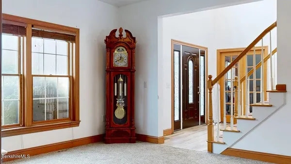 a kitchen with kitchen island a large window and cabinets