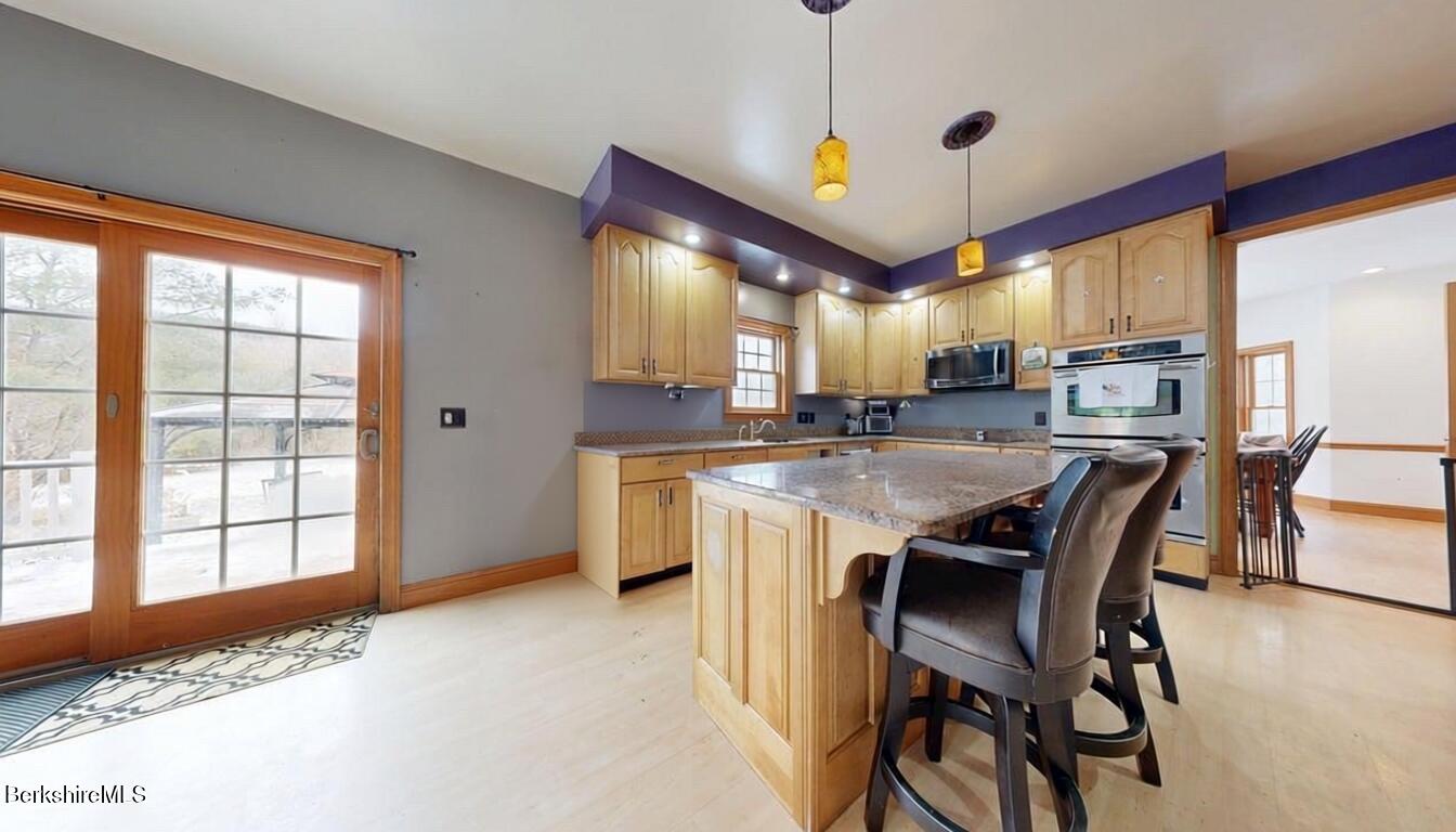 867 Notch Road Cheshire, MA 01225 - Photo 15 of 37 a kitchen with kitchen island a large window and cabinets