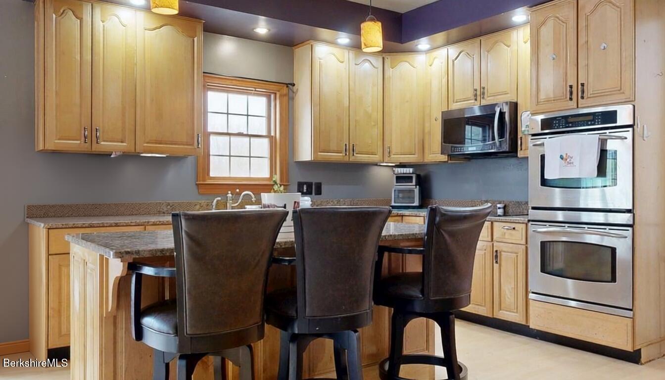 867 Notch Road Cheshire, MA 01225 - Photo 17 of 37 a kitchen with stainless steel appliances granite countertop a stove a sink and a refrigerator