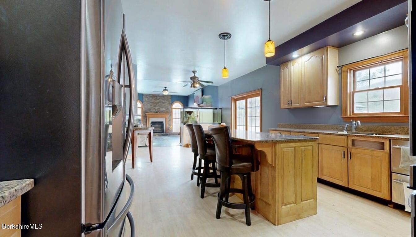 867 Notch Road Cheshire, MA 01225 - Photo 18 of 37 a kitchen with stainless steel appliances granite countertop dining table chairs and granite counter tops