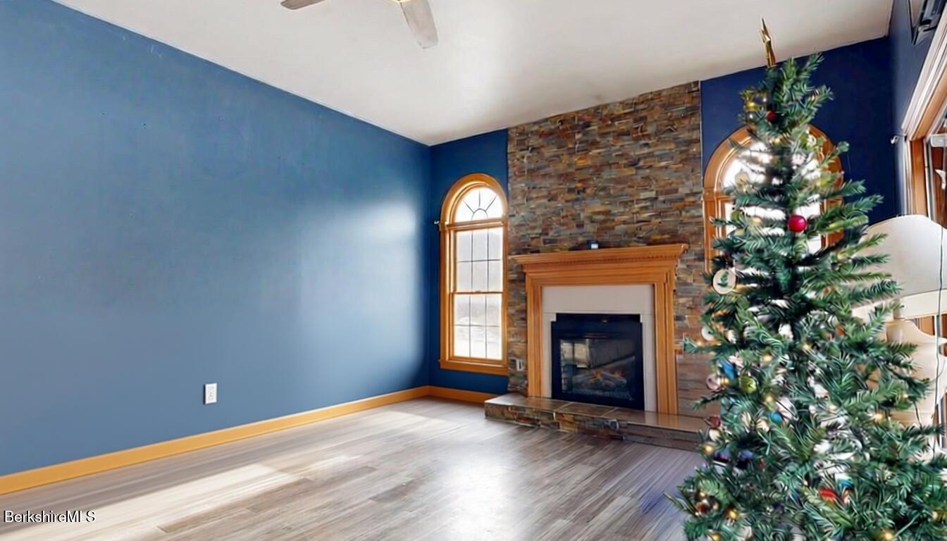867 Notch Road Cheshire, MA 01225 - Photo 20 of 37 a view of an empty room with wooden floor fireplace and a window