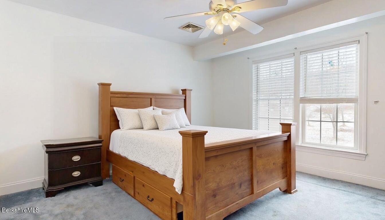 867 Notch Road Cheshire, MA 01225 - Photo 29 of 37 a bed room with a bed and a chandelier