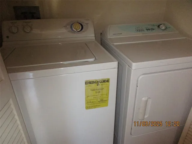 a view of a hallway with wooden floor and a chandelier