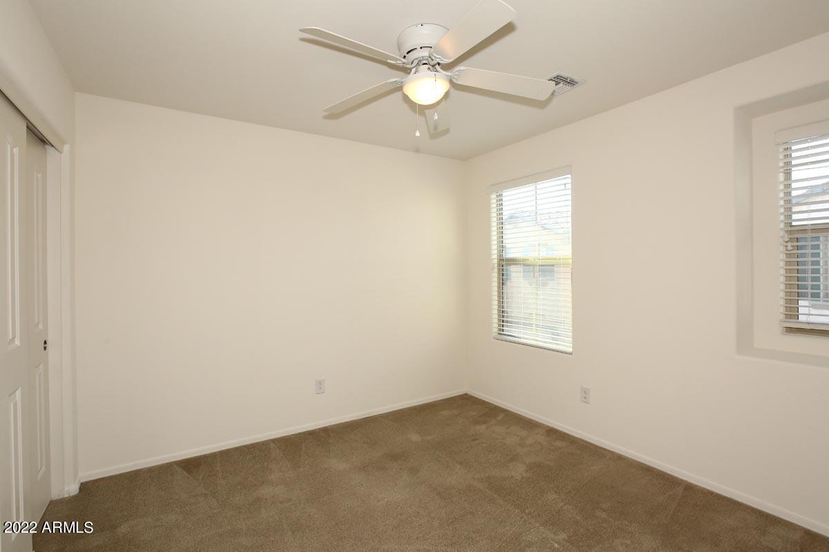 4717 East Betty Elyse Lane Phoenix, AZ 85032 - Photo 14 of 25 an empty room with a window and a fan