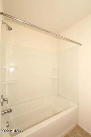 a bathroom with a shower and a glass door