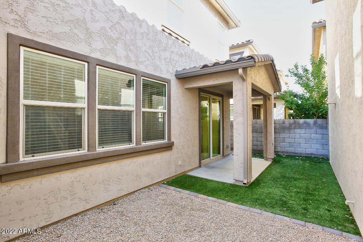 4717 East Betty Elyse Lane Phoenix, AZ 85032 - Photo 23 of 25 a view of a brick house with a large windows and a yard with plants