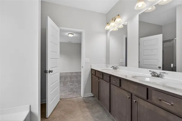 a bathroom with a granite countertop sink a large mirror and a shower