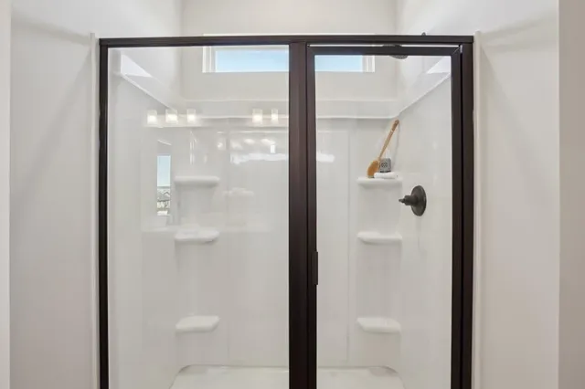 a bathroom with a glass shower door