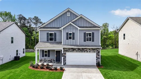 a front view of house with yard and green space
