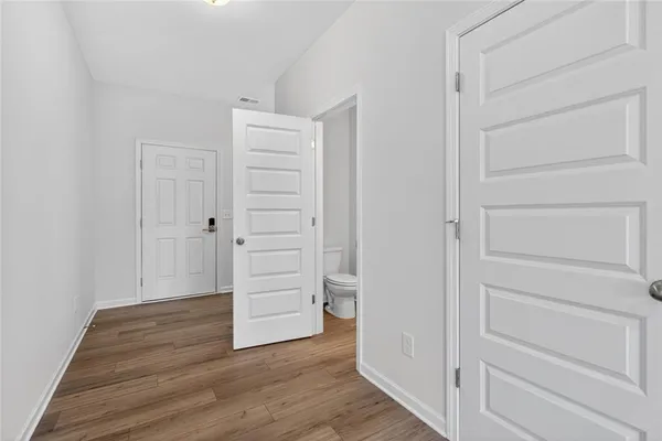a view of walk in closet with empty racks