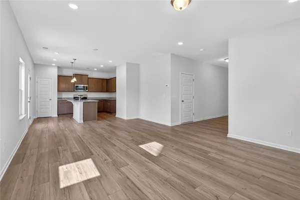 a view of kitchen and a sink wooden floor