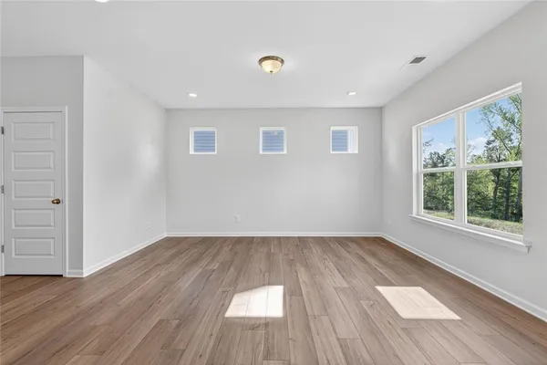 wooden floor in an empty room with a window