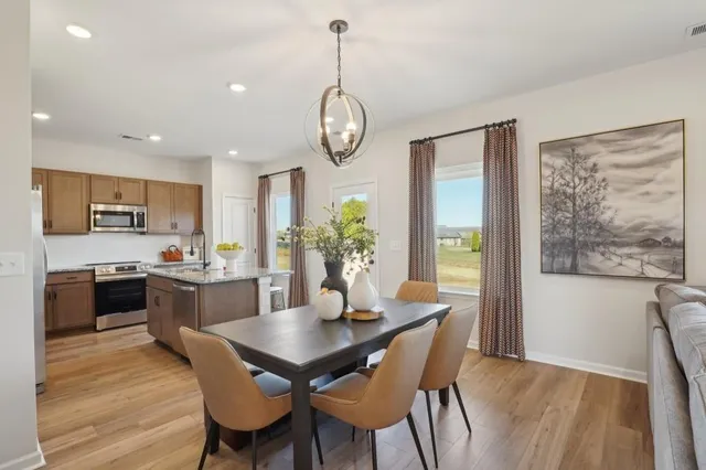a view of a dining room with furniture window and wooden floor