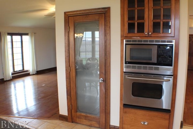 7777 Adam Road Weldon, IL 61882 - Photo 5 of 24 a kitchen with granite countertop a stove and a refrigerator