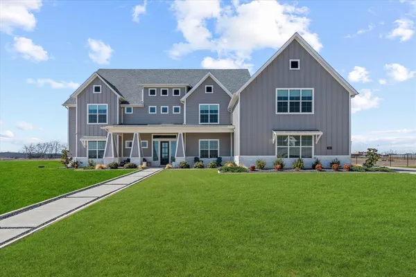 a front view of house with yard and green space