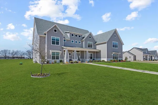 a front view of house with yard and green space