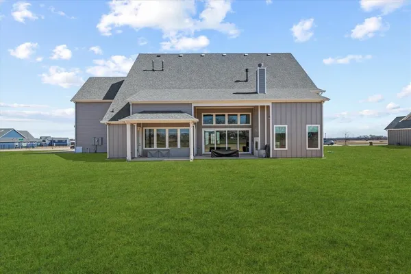a view of an house with backyard porch and sitting area
