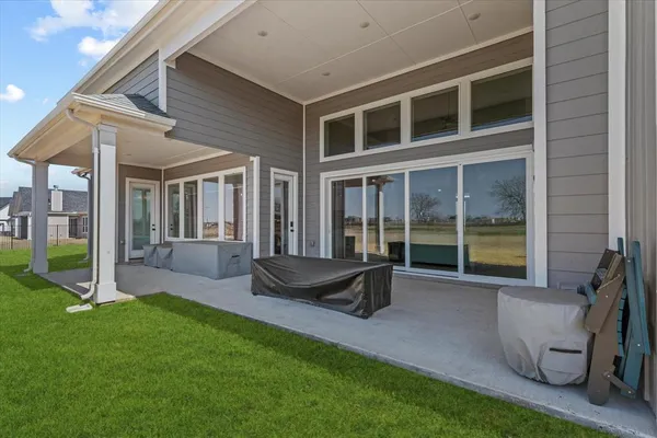 a aerial view of a house next to a big yard and large trees