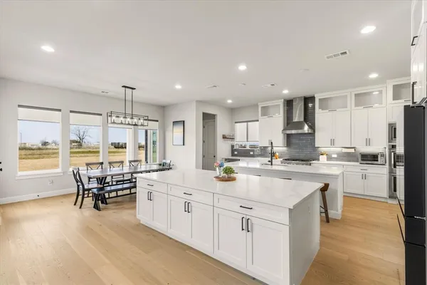 a large white kitchen with a large window
