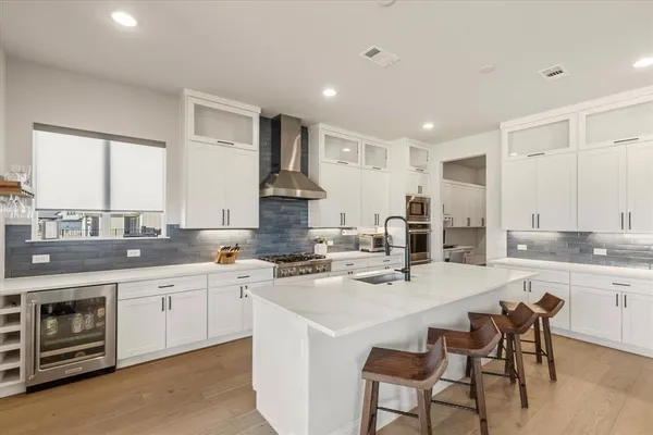 a kitchen with stainless steel appliances a sink stove and cabinets