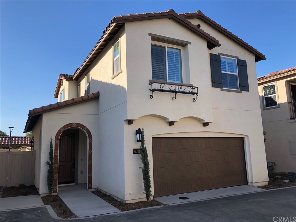 a front view of a house with plants