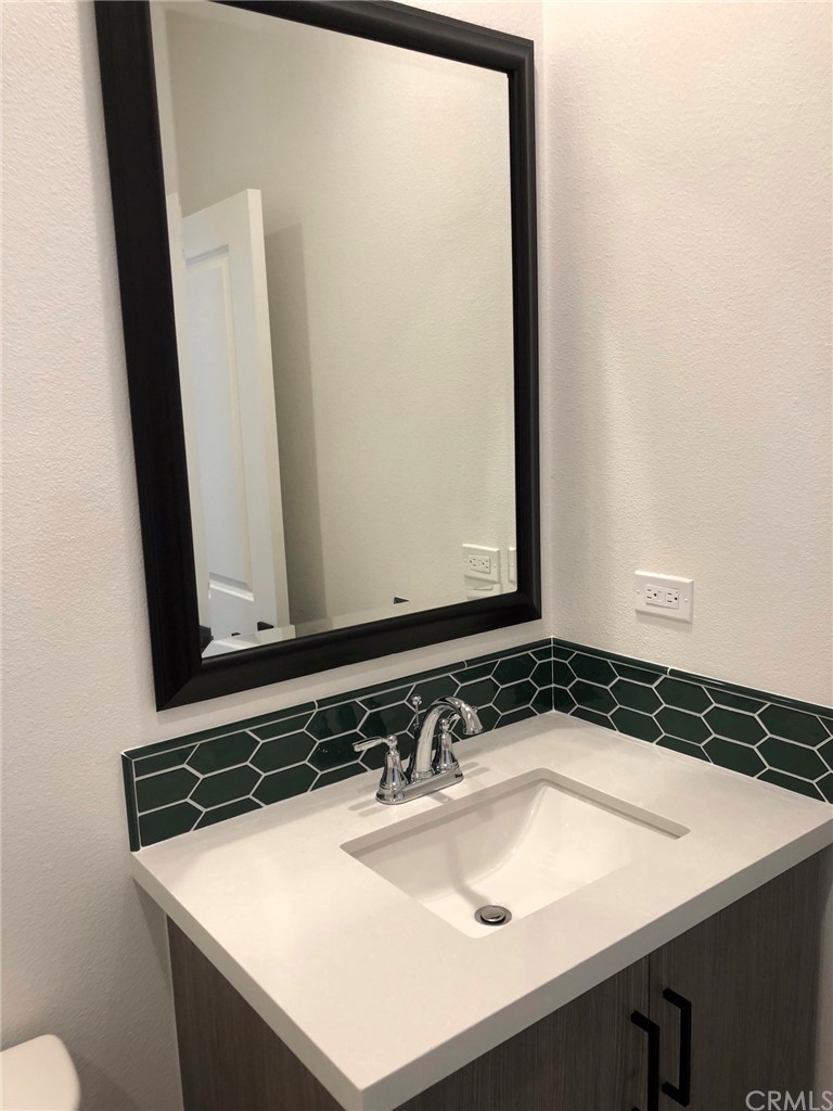 45283 Via Vela Temecula, CA 92592 - Photo 10 of 26 a close up of a sink and a mirror