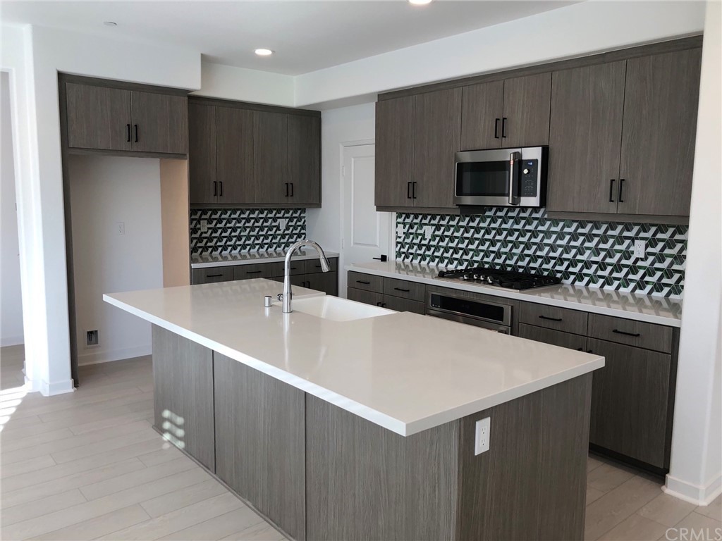 45283 Via Vela Temecula, CA 92592 - Photo 3 of 26 a kitchen with a sink cabinets and appliances