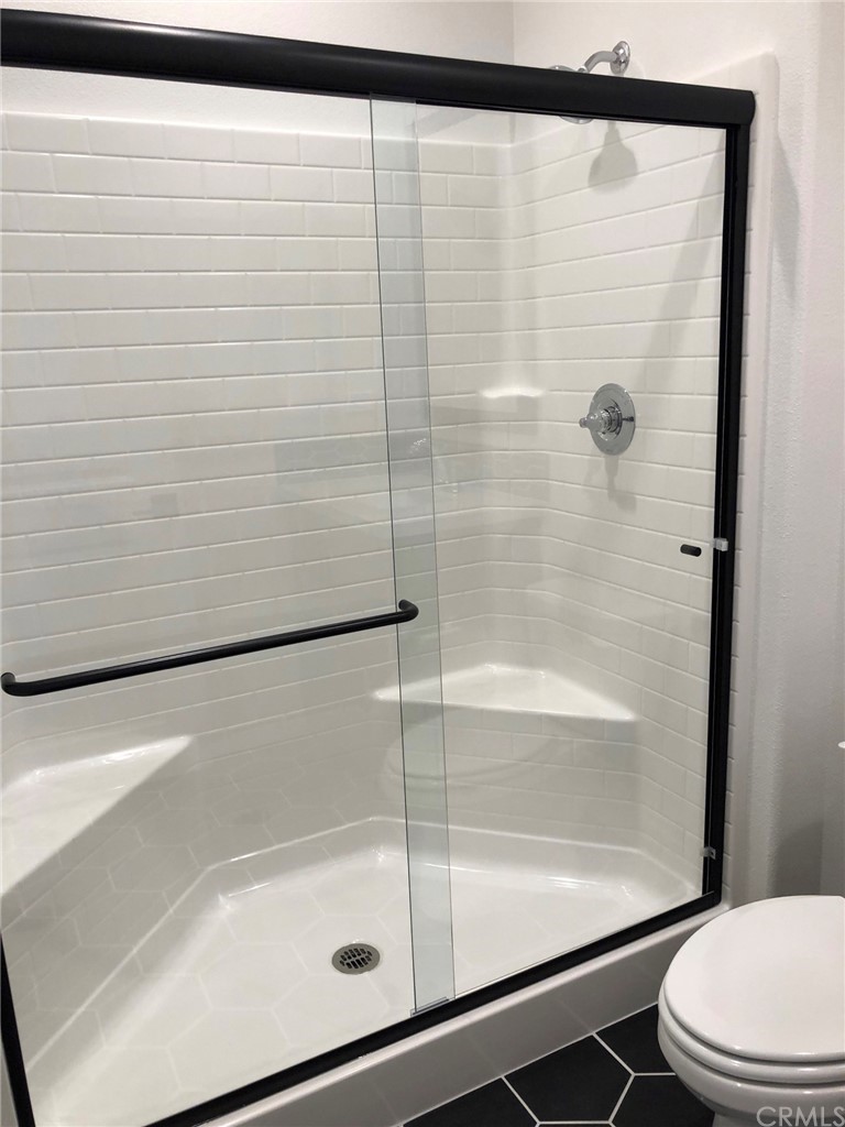 45283 Via Vela Temecula, CA 92592 - Photo 9 of 26 a bathroom with a shower and a toilet