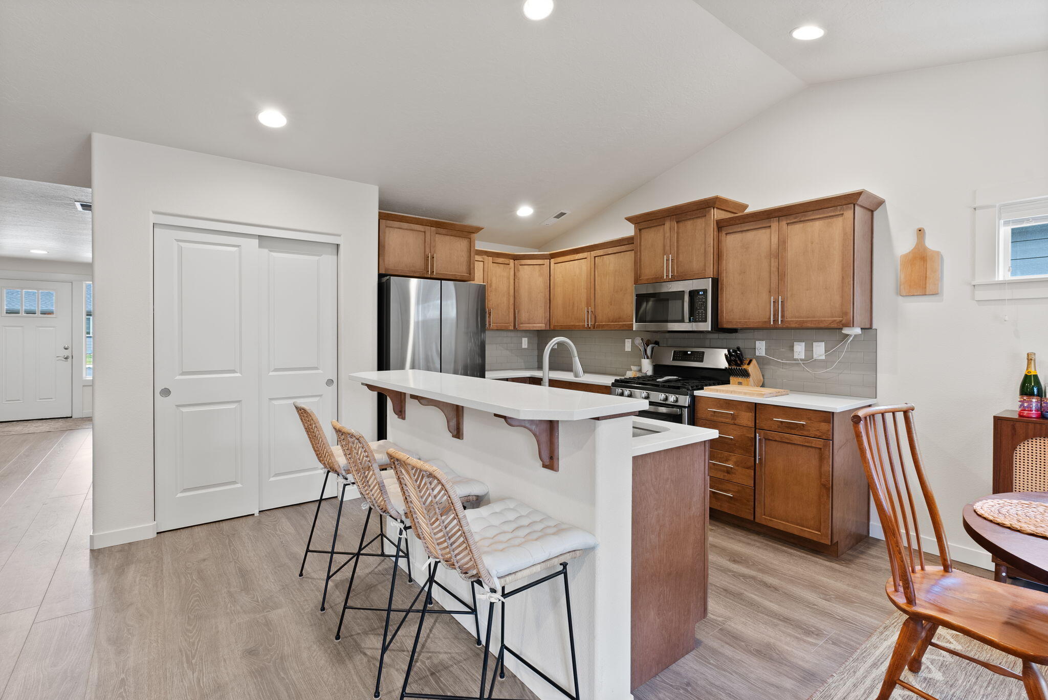 632 North Reed Street Sisters, OR 97759 - Photo 10 of 36 a kitchen with granite countertop wooden floors cabinets a sink and appliances