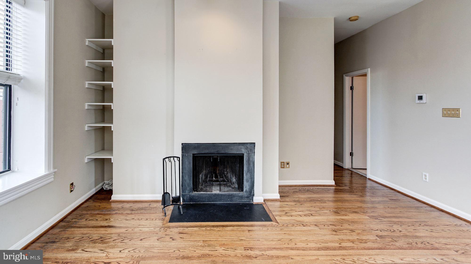 2101 N Street Northwest, Unit 301 Washington, DC 20037 - Photo 6 of 16 Wood-burning fireplace and shelving