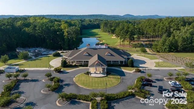 an aerial view of a house with swimming pool and green space