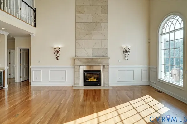 a view of an empty room window and wooden floor