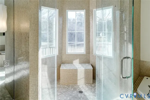 a bathroom with a granite countertop shower and a sink