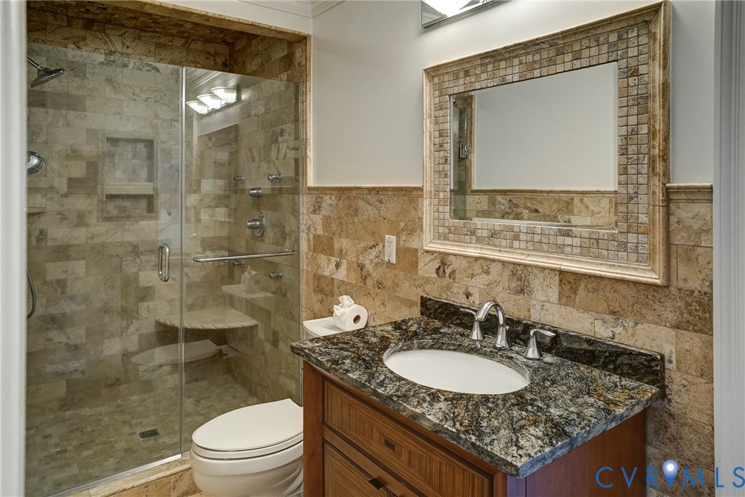 721 Meadow View Ridge Manakin-Sabot, VA 23103 - Photo 37 of 50 a bathroom with a granite countertop sink a toilet and a mirror
