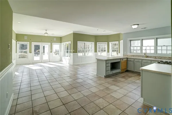 a room with pool table and windows