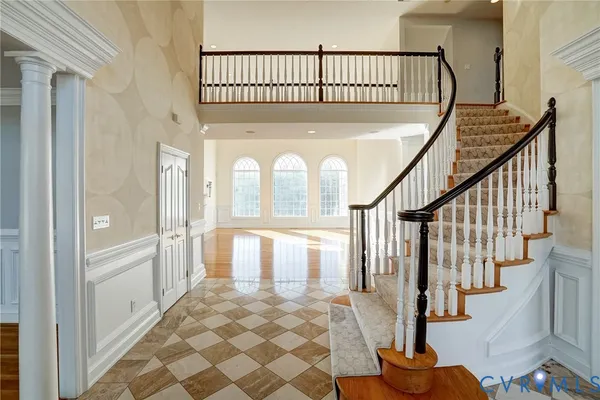 a view of entryway with wooden floor and a front door