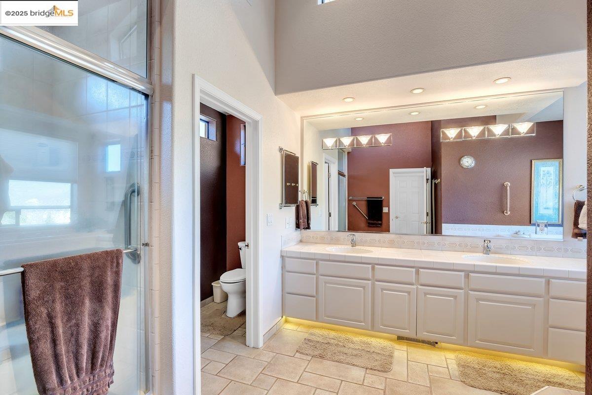 13700 Clements Road Groveland, CA 95321 - Photo 30 of 93 Bathroom with a stall shower, double vanity, and healthy amount of natural light