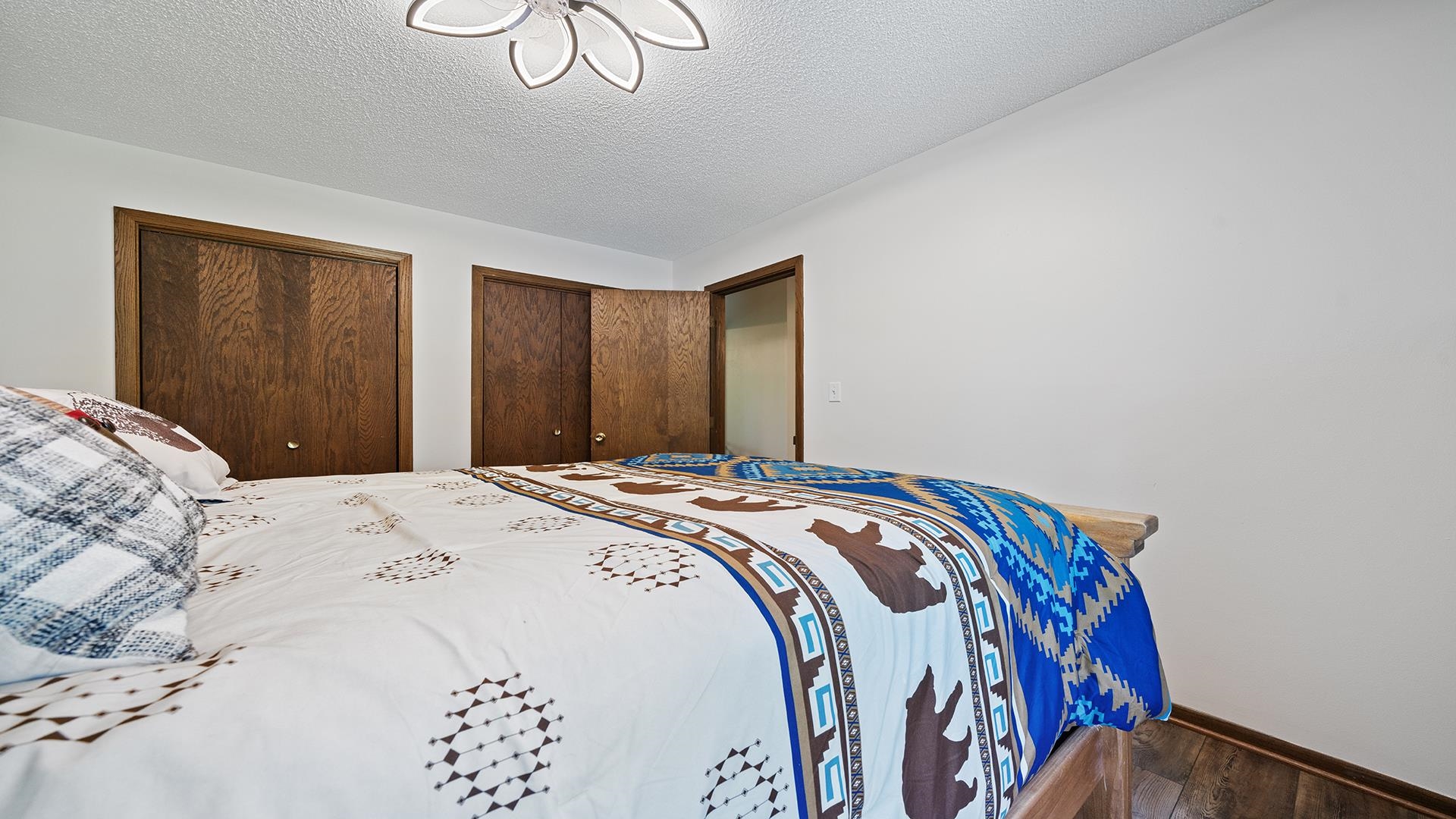 293 Briar Court Oregon, IL 61061 - Photo 30 of 58 a bedroom with a bed and a chandelier