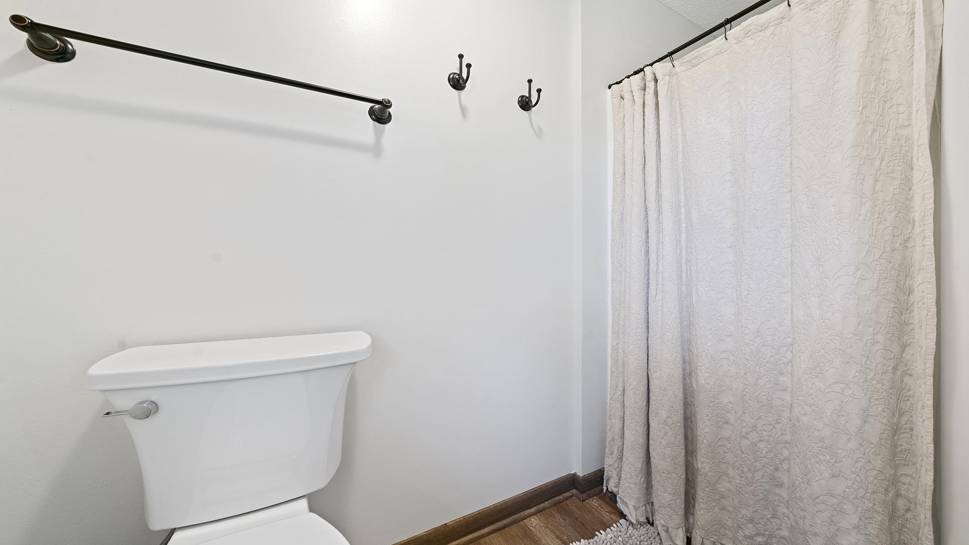 293 Briar Court Oregon, IL 61061 - Photo 39 of 58 a white toilet sitting next to a shower curtain