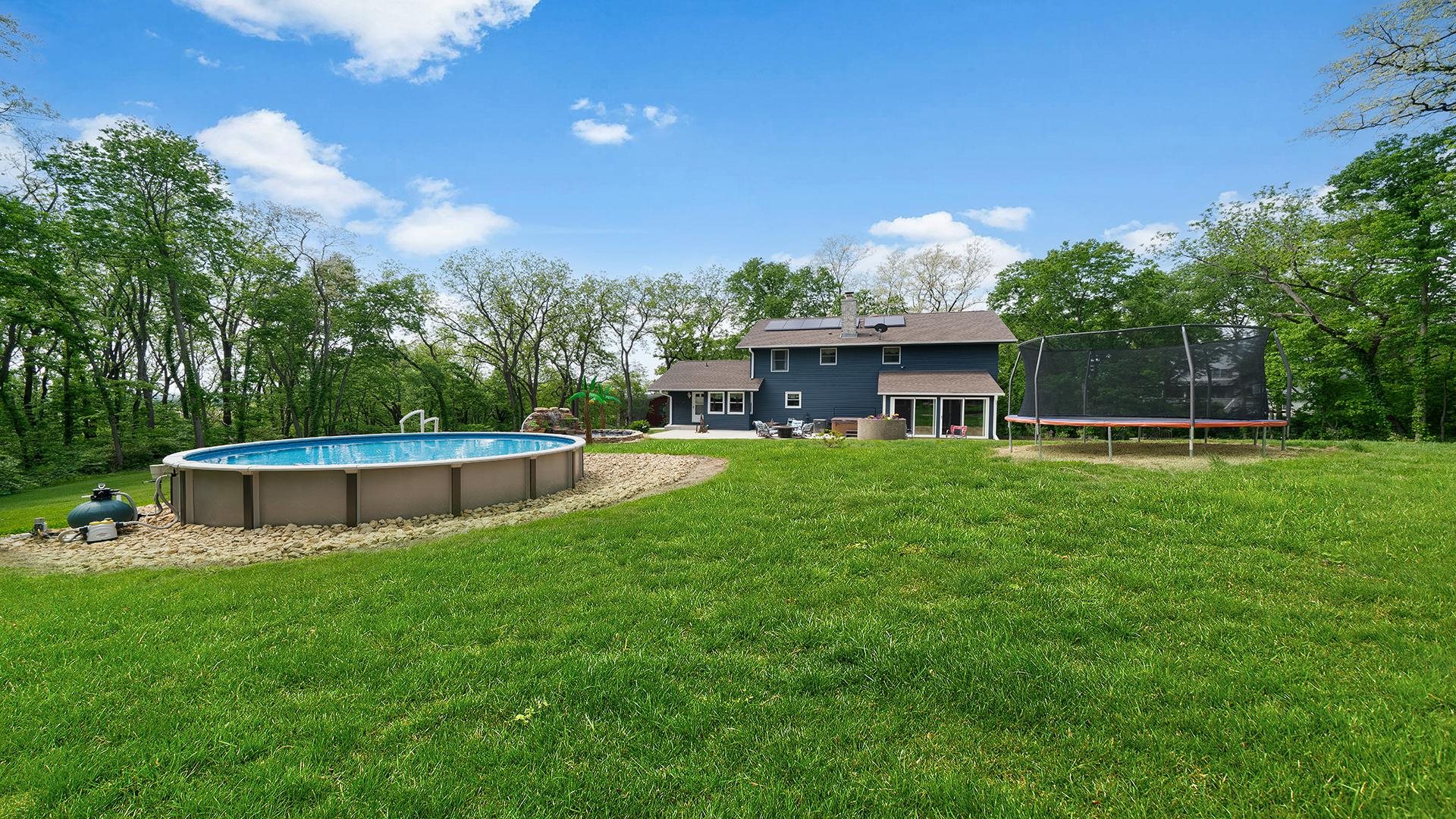 293 Briar Court Oregon, IL 61061 - Photo 49 of 58 a view of a house with a swimming pool and a yard