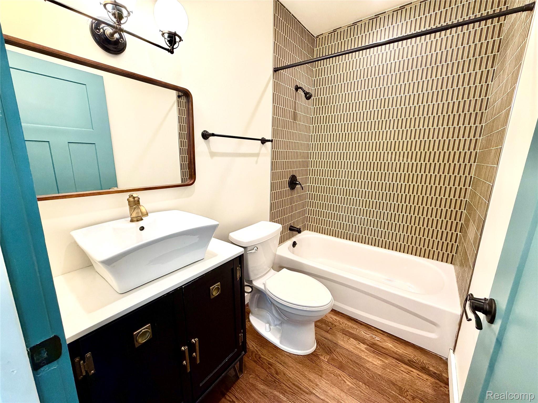 2045 Calvert Avenue Detroit, MI 48206 - Photo 32 of 41 Bathroom featuring vanity, bathtub / shower combination, and dark wood finished floors