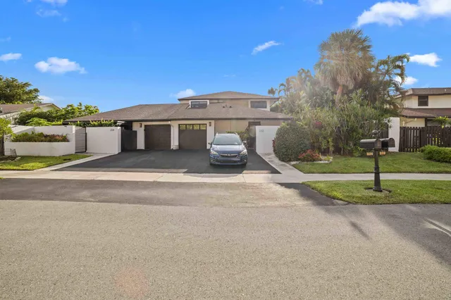 a front view of a house with a garden and yard