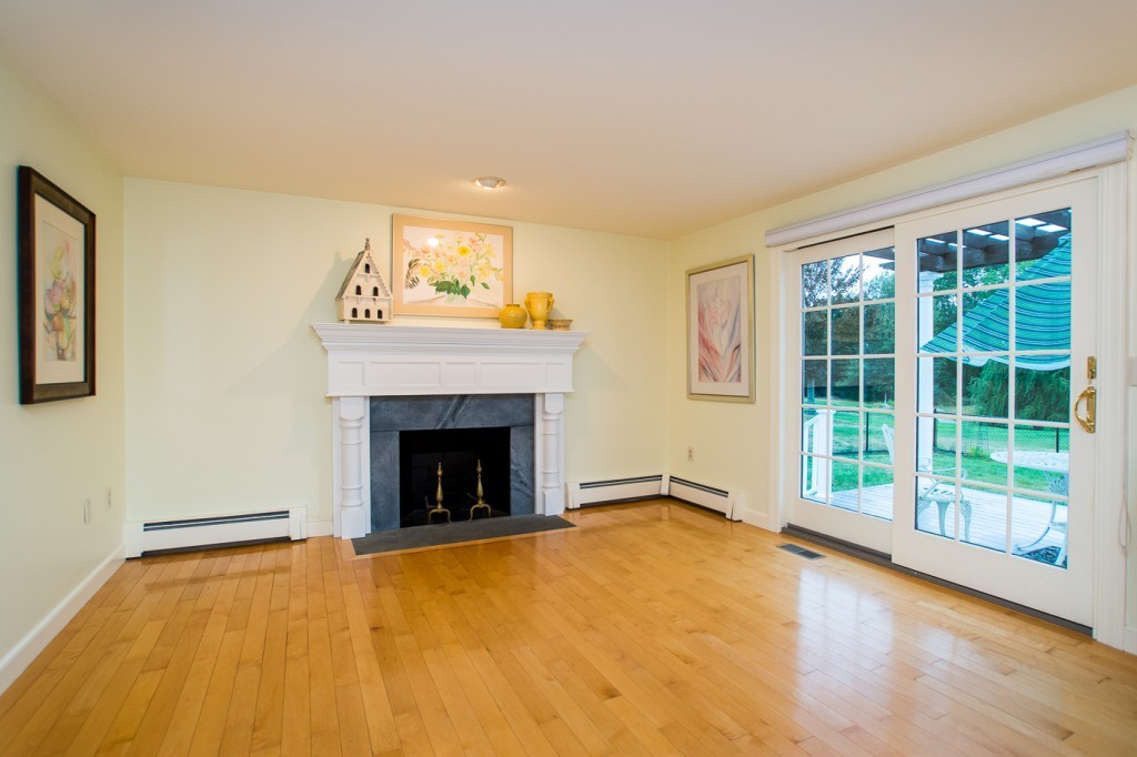 180 Westboro Road Upton, MA 01568 - Photo 8 of 30 a view of an empty room with a fireplace and a window