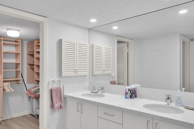 a bathroom with a sink mirror toilet and bathtub