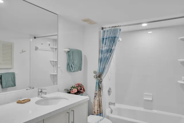 a bedroom with two beds and a chandelier