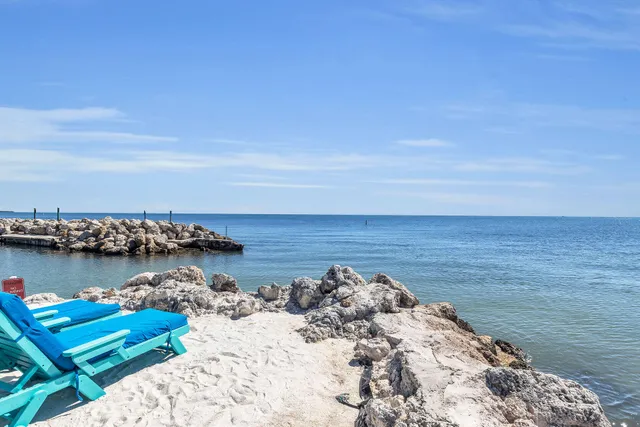 a front view of multi story residential apartment building with yard and entryway