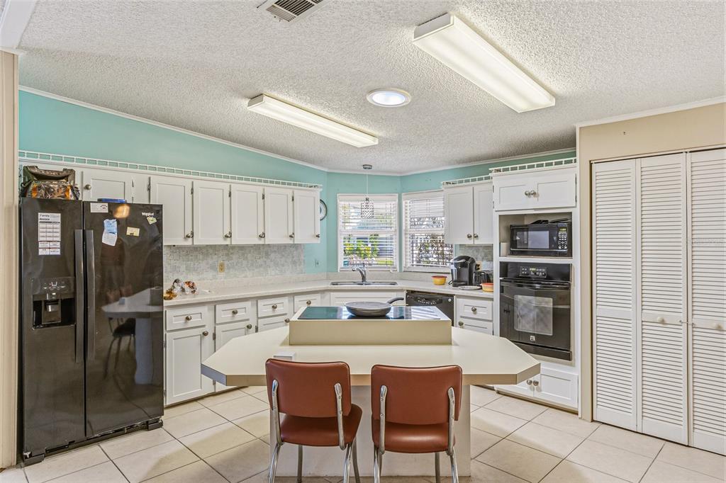 917 Cypress Street Sebastian, FL 32976 - Photo 23 of 80 a kitchen with stainless steel appliances granite countertop a refrigerator and a stove top oven